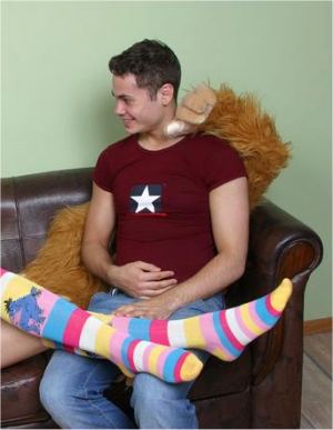 yobbo bogan man youth on couch 
with fluffy monkey chimp and teen girl in rainbow socks